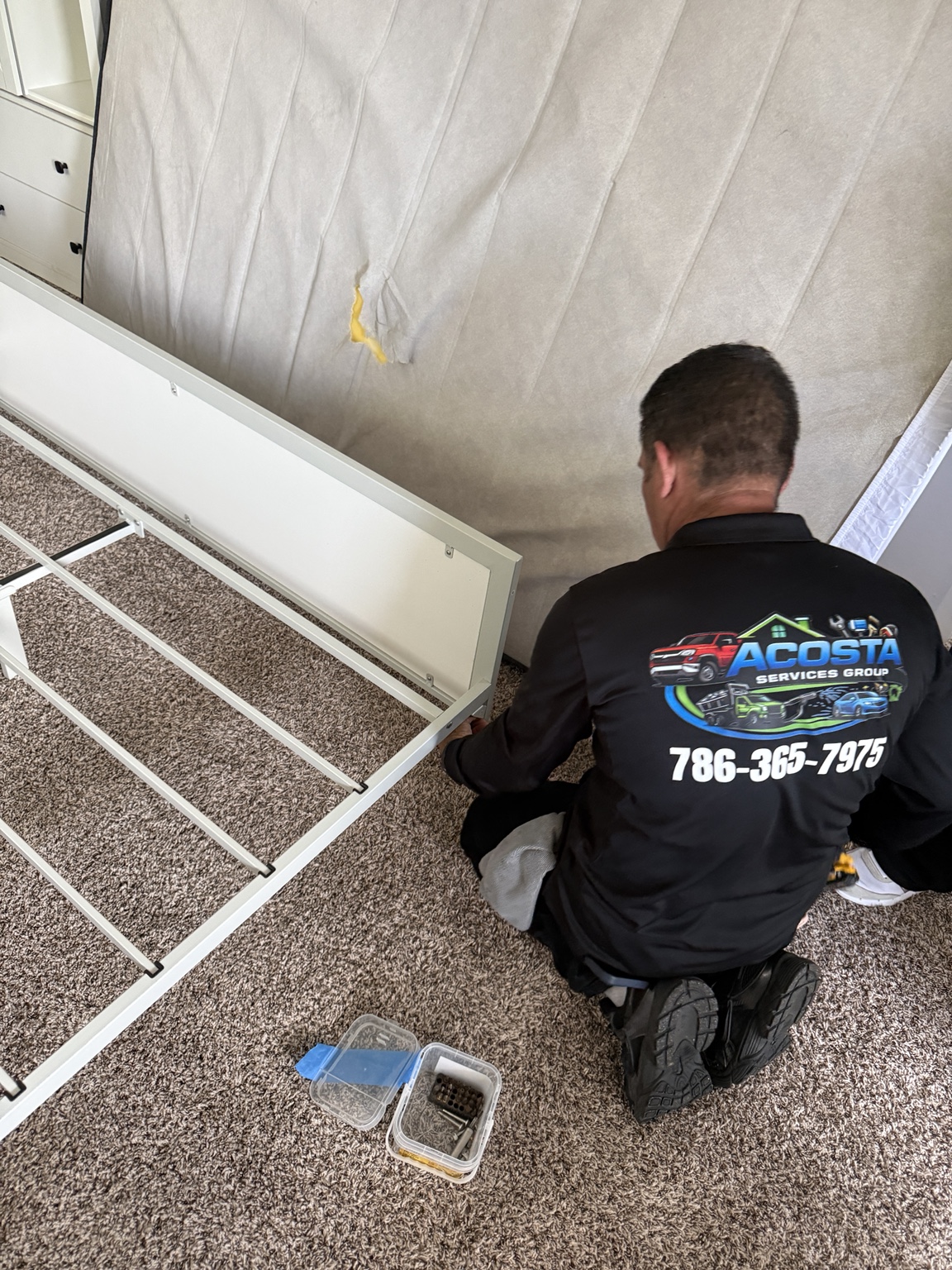 Acosta Services Group assembling a metal bed frame
