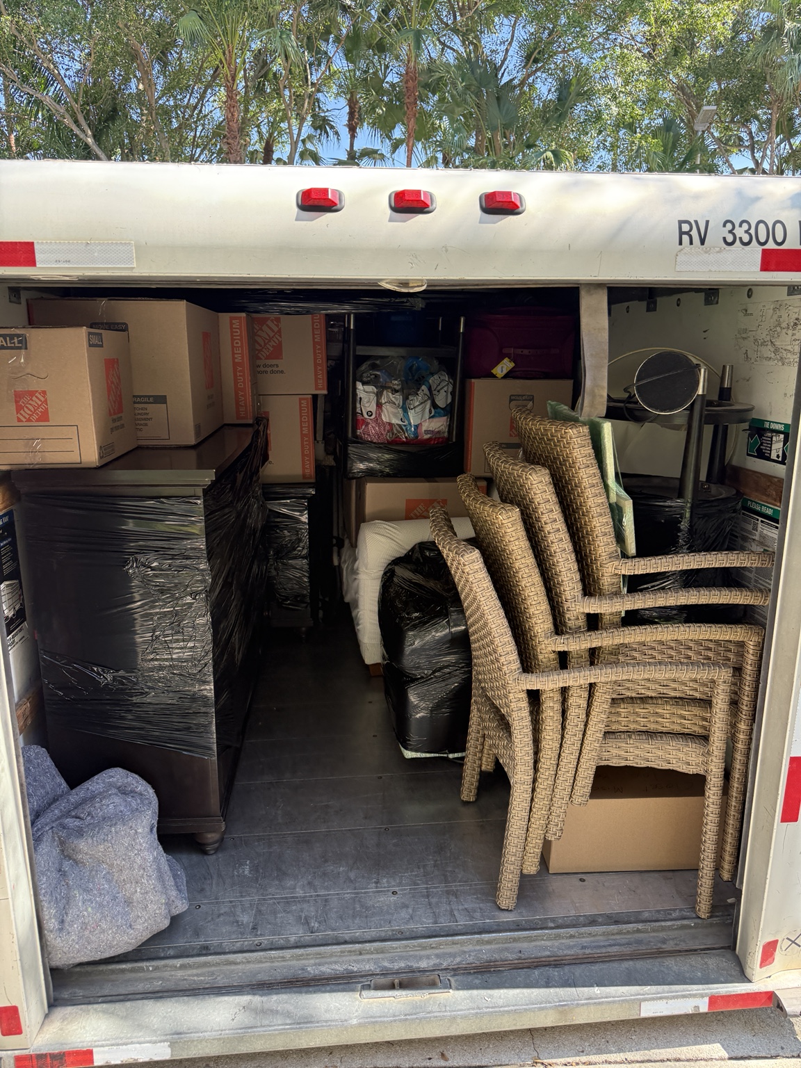 Boxes and wrapped furniture securely packed inside a moving truck