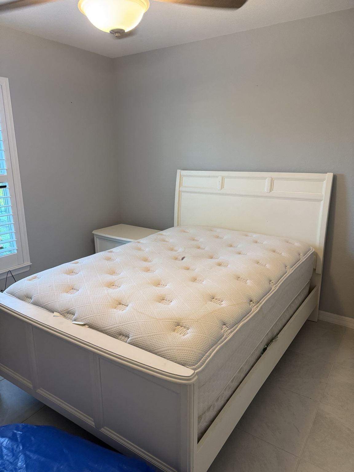 Completed white wooden bed frame and mattress after furniture assembly by Acosta Services Group
